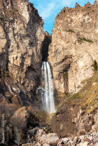 Scenic autumn landscape with vertical big Sultan waterfall at mountain top in sunshine in the Jila-Su tract. Kabardino-Balkaria. Russia  Caucasus. High falling water in Northern Elbrus region.