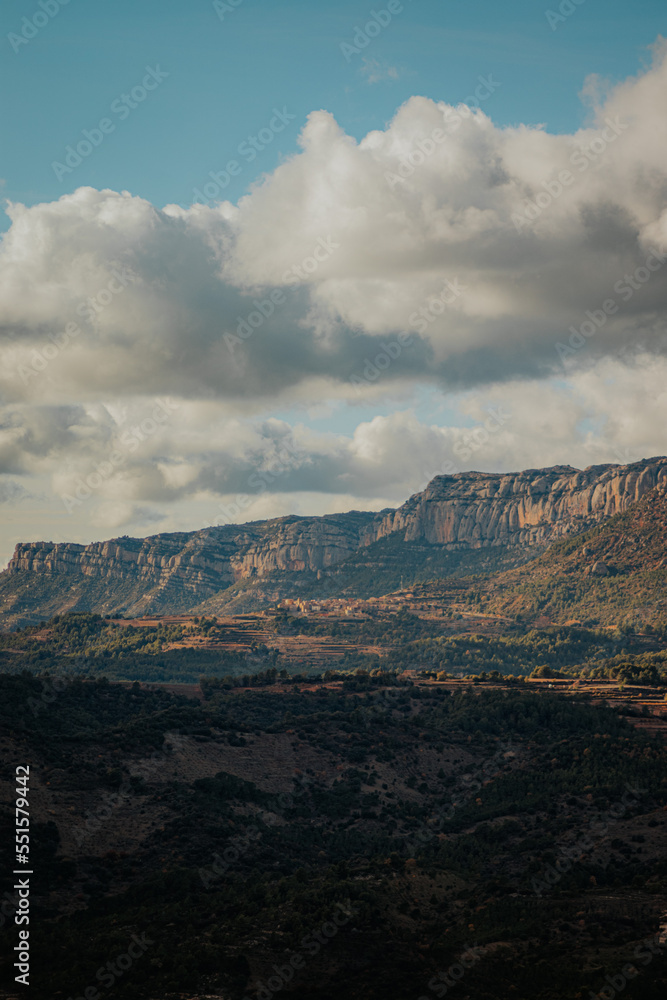 Vertical shot of valley slope with sunset sunlight and clouds. Vertical shot of valley slope with sunset sunlight and clouds.