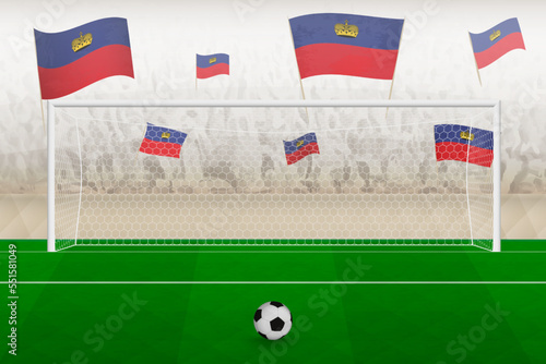 Liechtenstein football team fans with flags of Liechtenstein cheering on stadium, penalty kick concept in a soccer match.