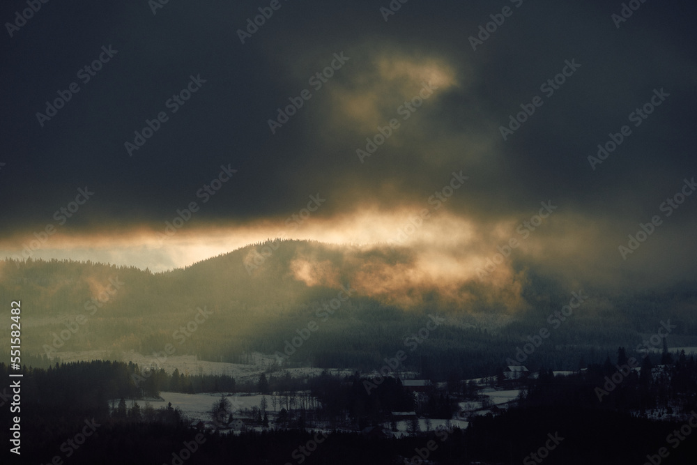 Winter clouds above the Totenåsen Hills, Norway, by sunset.