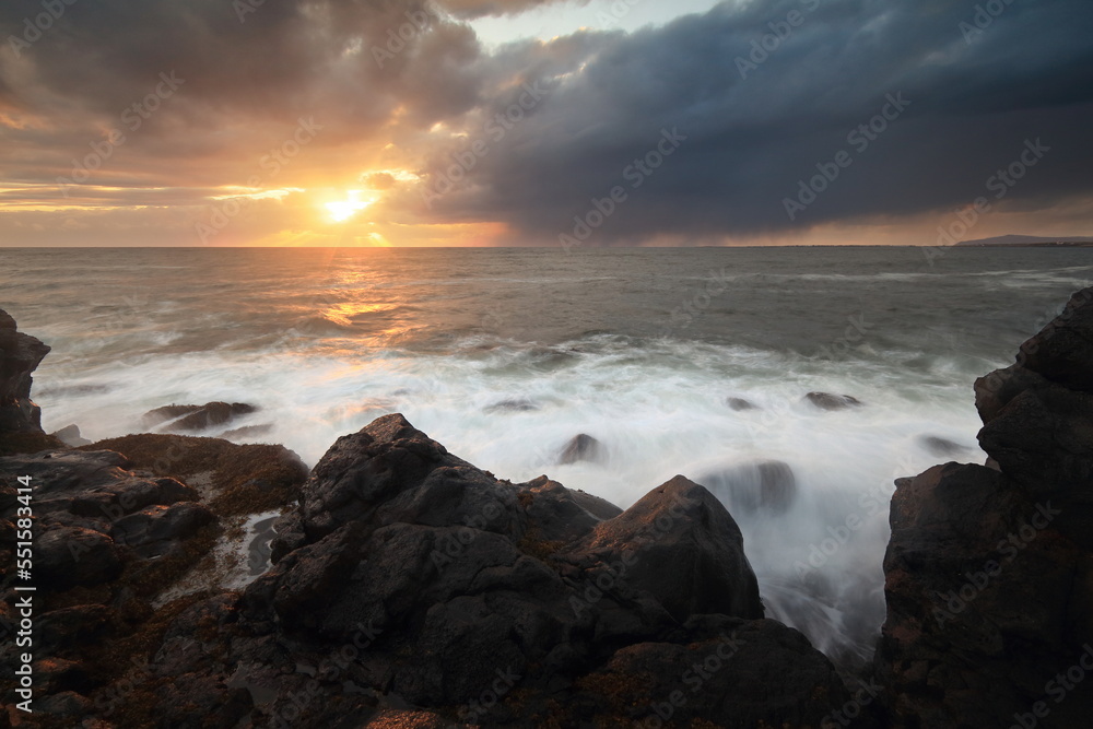 Sea wave on long exposure during sunset on the seashore