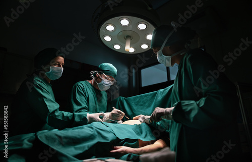 Obraz na plátně Medical team performing surgery in operation room.