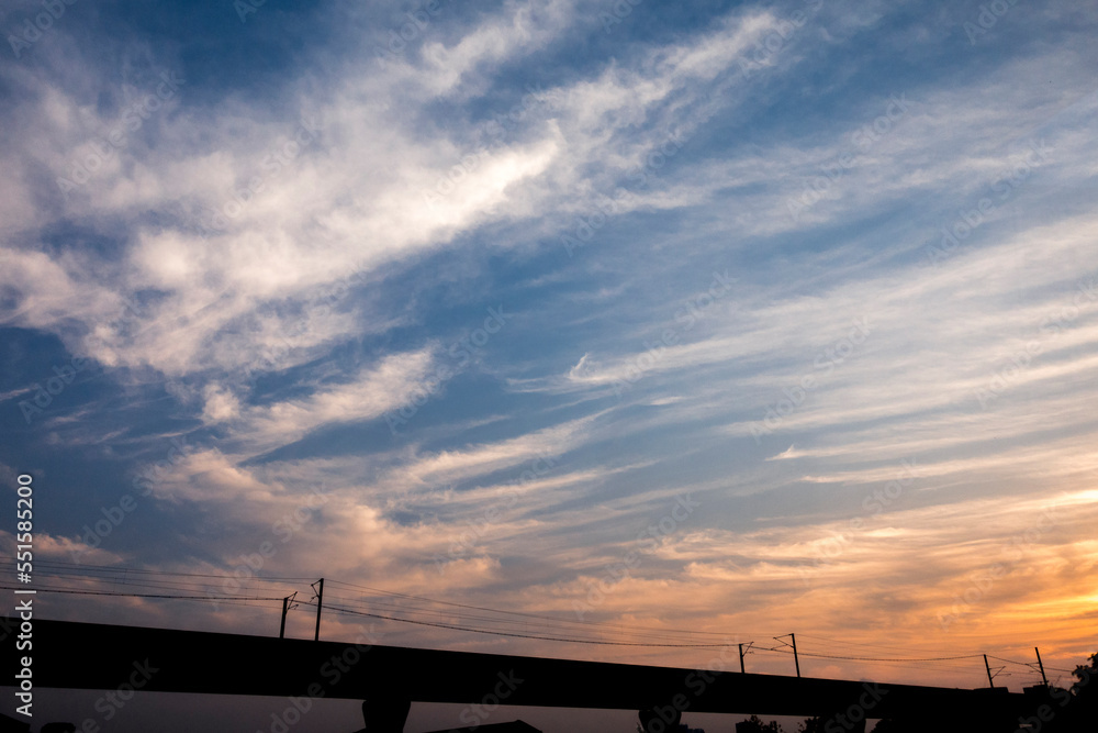 sunset or sun rise sky with rays of yellow and red light shining clouds and sky background and texture