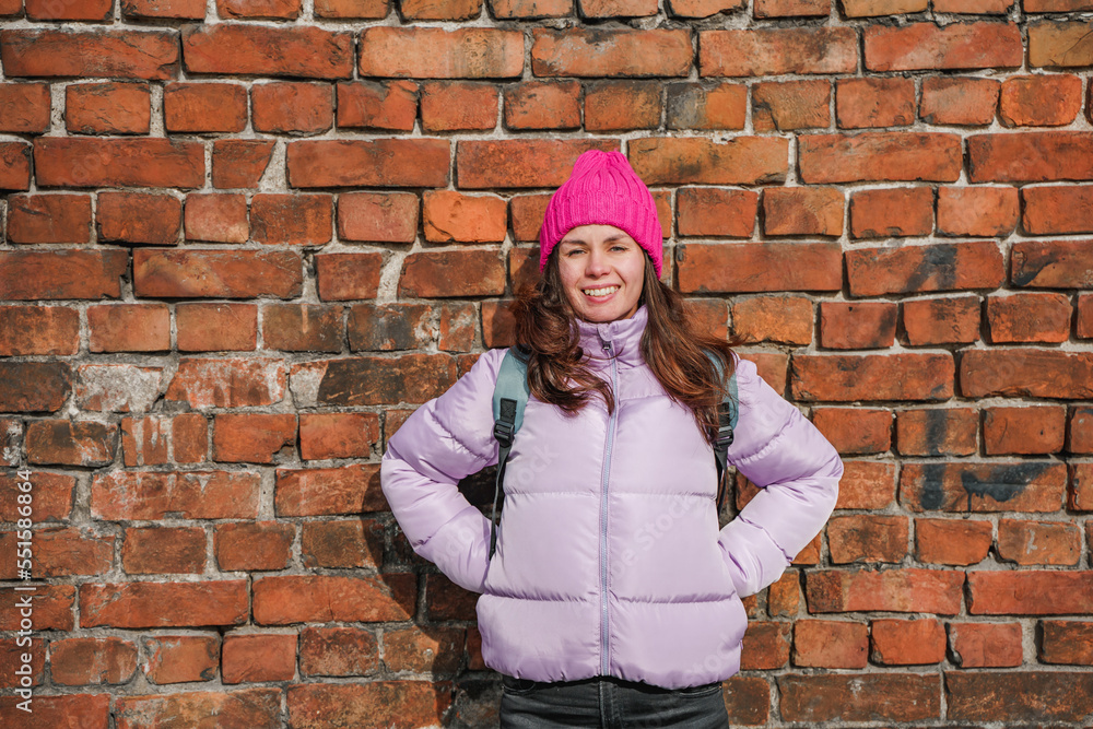 A young woman in a pink hat on a brick wall background, portrait A young woman in a pink hat on a brick wall background, portrait