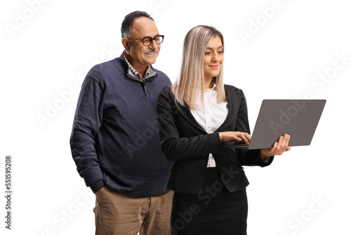 Businesswoman presenting something to a mature man on a laptop computer