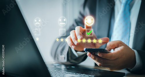 Customer service and Satisfaction concept. Business people are touching the virtual screen on the happy Smiley face icon to give satisfaction in service. rating very impressed. evaluation. Customer.