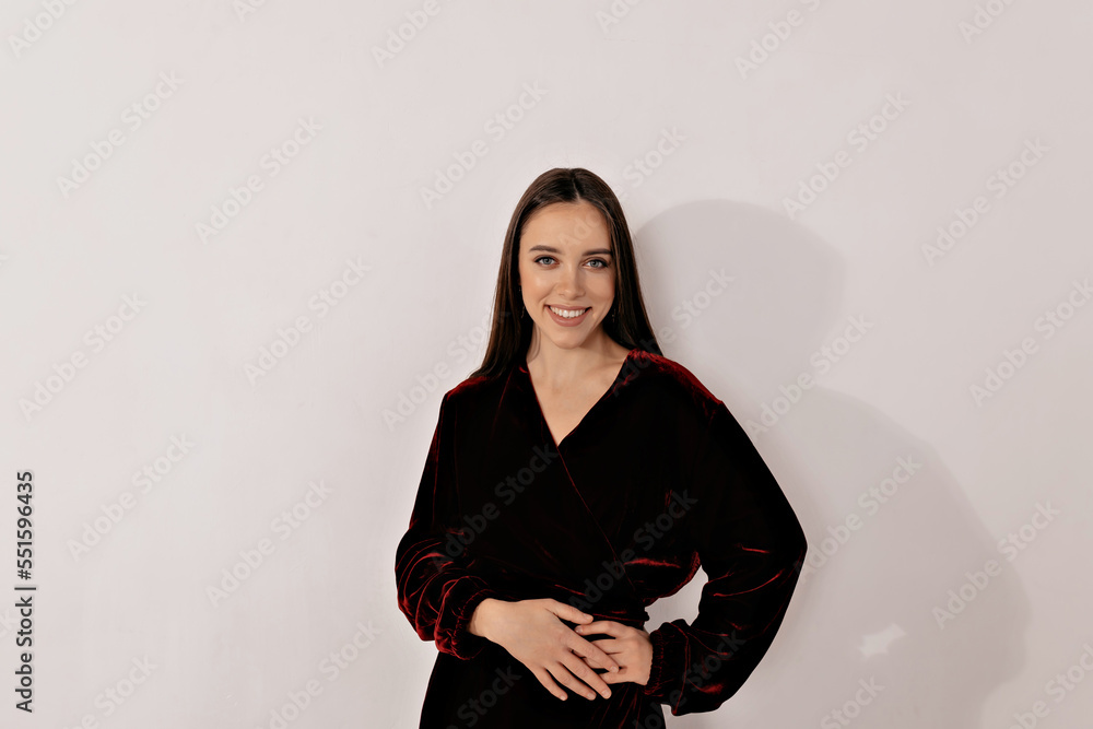 Smiling happy girl with wonderful smile wearing festive dress posing over isolated background. Happy emotions, holiday, celebration, new year, birthday Smiling happy girl with wonderful smile wearing festive dress posing over isolated background. Happy emotions, holiday, celebration, new year, birthday