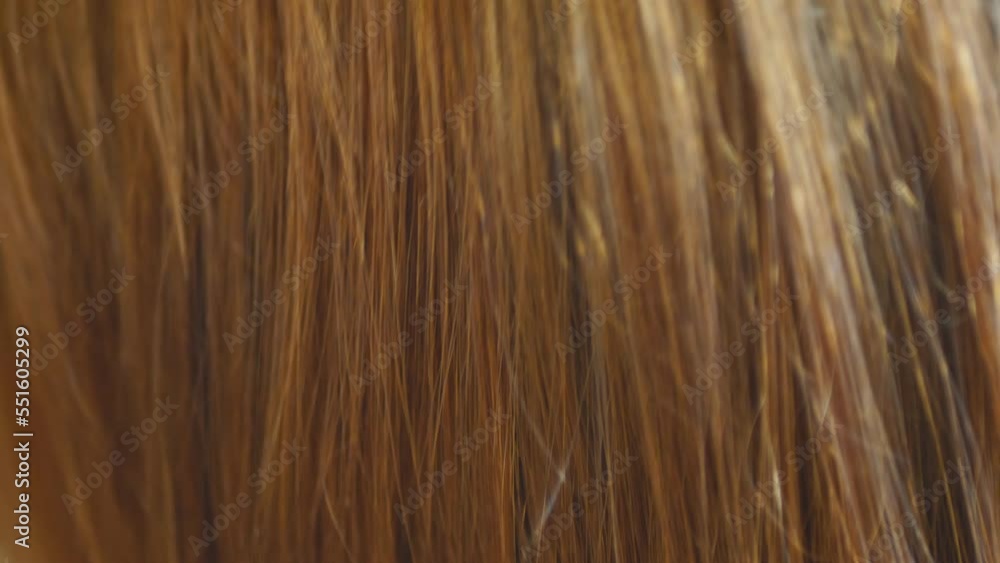 Combing red long hair with a comb Combing red long hair with a comb