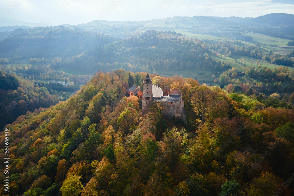 Aerial top view of Grodno castle in Zagorze with beautiful autumn landscape. Old historical fortress in mountains, covered with forest. Poland landmarks for tourists