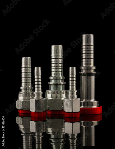 Set of fittings, quick couplings for hose isolated on black background.