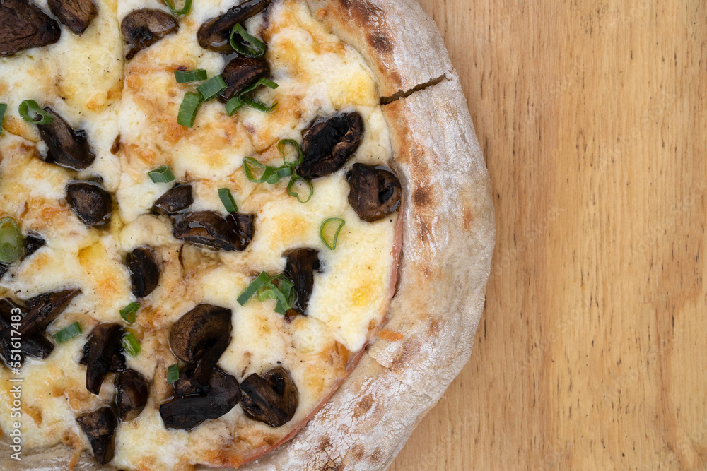 Mushrooms pizza. Top view of a pizza with provolone and mozzarella cheese, tomato sauce and champignons. Mushrooms pizza. Top view of a pizza with provolone and mozzarella cheese, tomato sauce and champignons.