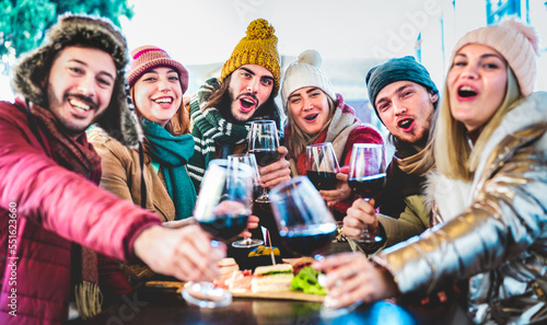 Foto Young trendy friends toasting red wine at restaurant garden out side - Life styl