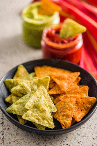 Tortilla chips with the flavor of chili and jalapeno peppers on plate.