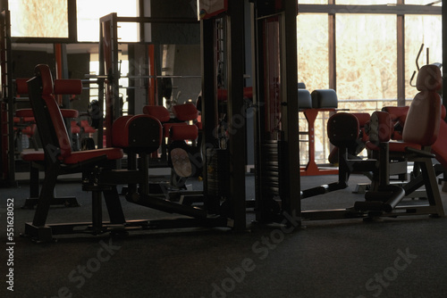 Sports equipment in the gym. Stylish sports space. Expanders and trainers with block weights