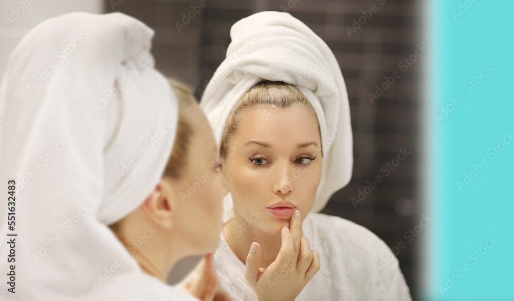 Woman looking in the mirror Applying the cream..Magic anti-aging cream Woman looking in the mirror Applying the cream..Magic anti-aging cream