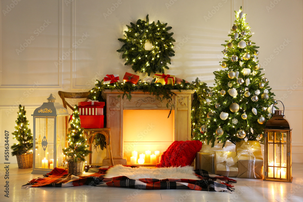 Fototapeta premium Beautiful Christmas themed photo zone with fireplace and fir decor