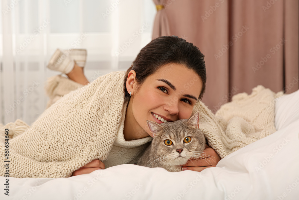 Young woman with adorable cat at home Young woman with adorable cat at home
