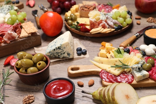 Many different appetizers served on wooden table