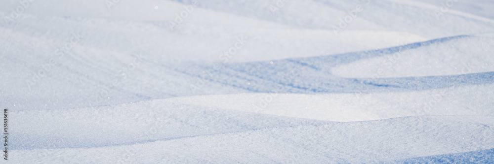Beautiful winter background with snowy ground. Natural snow texture. Wind sculpted patterns on snow surface. Arctic, Polar region. Beautiful winter background with snowy ground. Natural snow texture. Wind sculpted patterns on snow surface. Arctic, Polar region.
