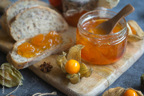 Картината върху платно Tasty, fragrant jam and physalis fruits on the table.