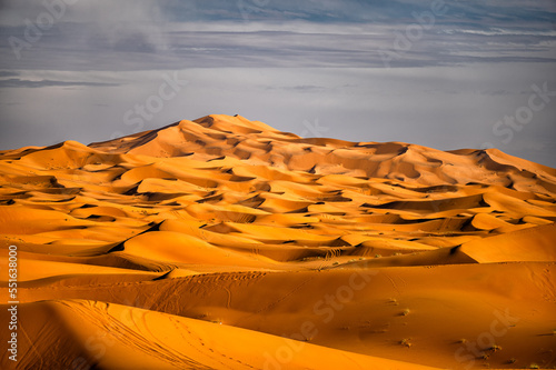 Sahara Desert sand dunes background. Popular travel destination, Erg Chebbi, Sahara Desert, Morocco. photo