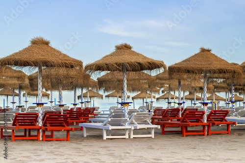 Palm umbrellas on the beach in the popular resort of Torremolinos on the Mediterranean Sea in Spain. photo