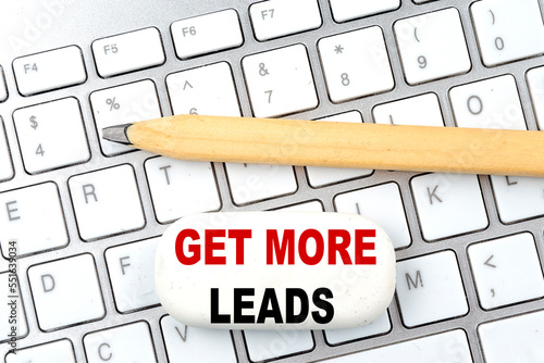 GET MORE LEADS text on eraser with pencil on keyboard
