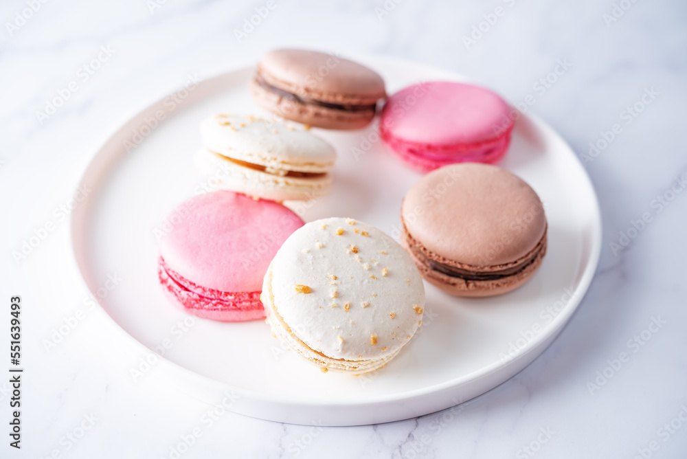 Fototapeta premium Sweet multicoloured macarons on a bright background