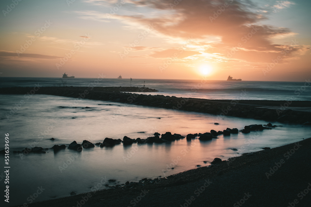 Fototapeta premium Beautiful sunset long exposure with rocks, Civitavecchia (Rome) Italy