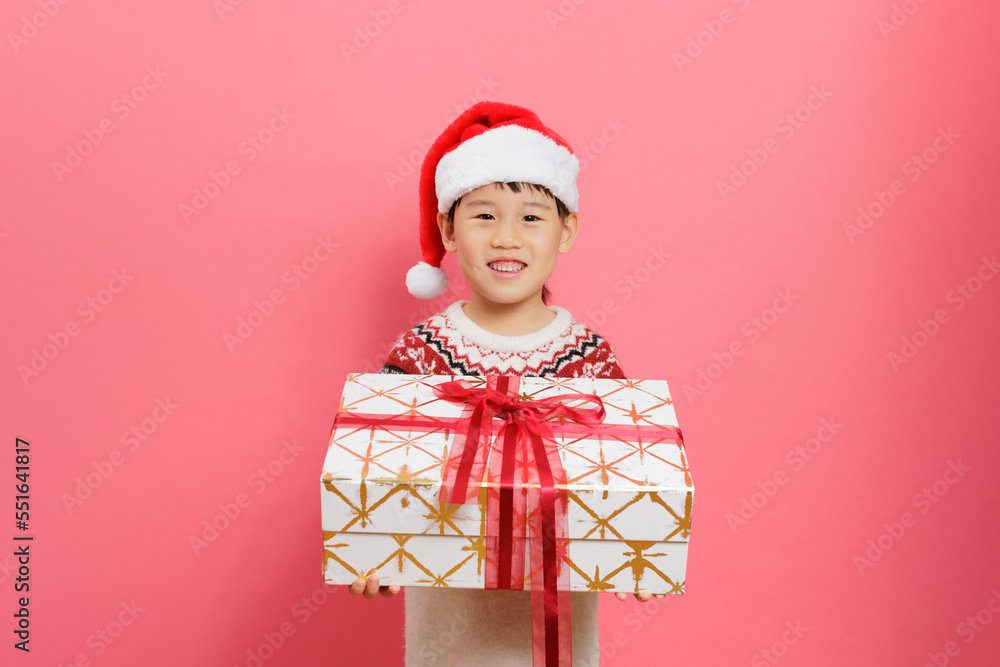 Merry Christmas! Young girl celebrating Christmas against pink background Merry Christmas! Young girl celebrating Christmas against pink background