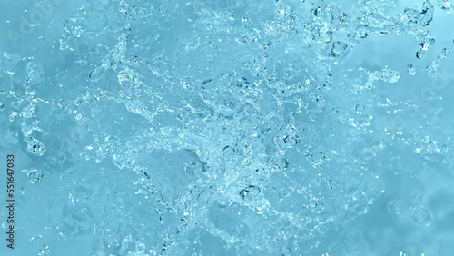Water splash isolated on soft blue background.