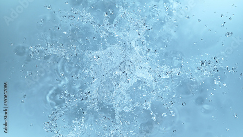 Water splash isolated on soft blue background.