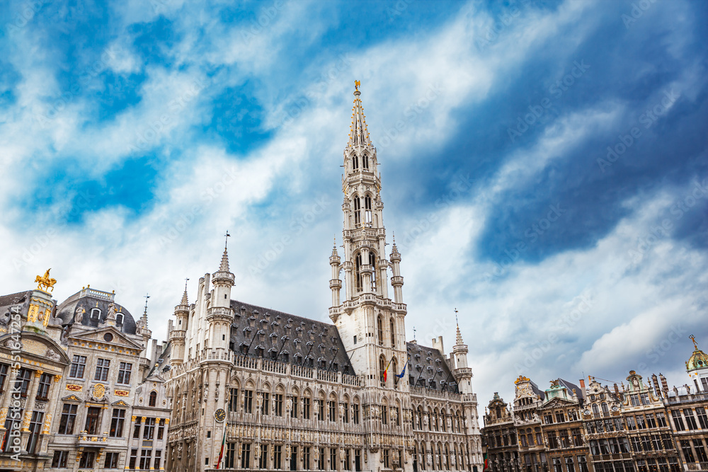 Fototapeta premium Brussels Town Hall building with tall spire and other guild houses in the Grand Place in Brussels, Belgium