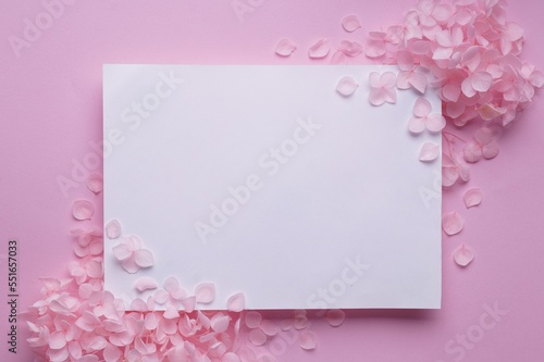 Beautiful hortensia flowers and sheet of paper on pink background, flat lay. Space for text © New Africa