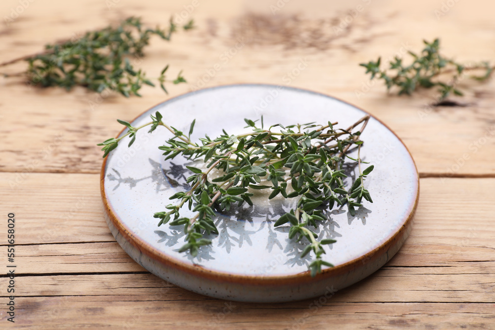 Board with fresh thyme on wooden table Board with fresh thyme on wooden table