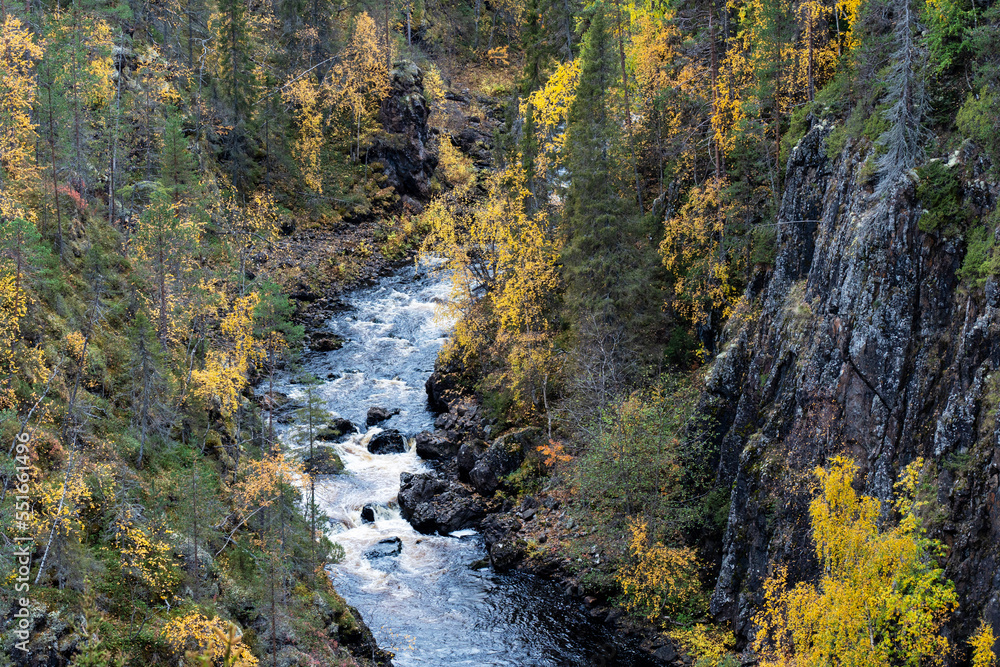 Water flowing in rapids in a canyon in autumnal Oulanka National Park, Northern Finland Water flowing in rapids in a canyon in autumnal Oulanka National Park, Northern Finland