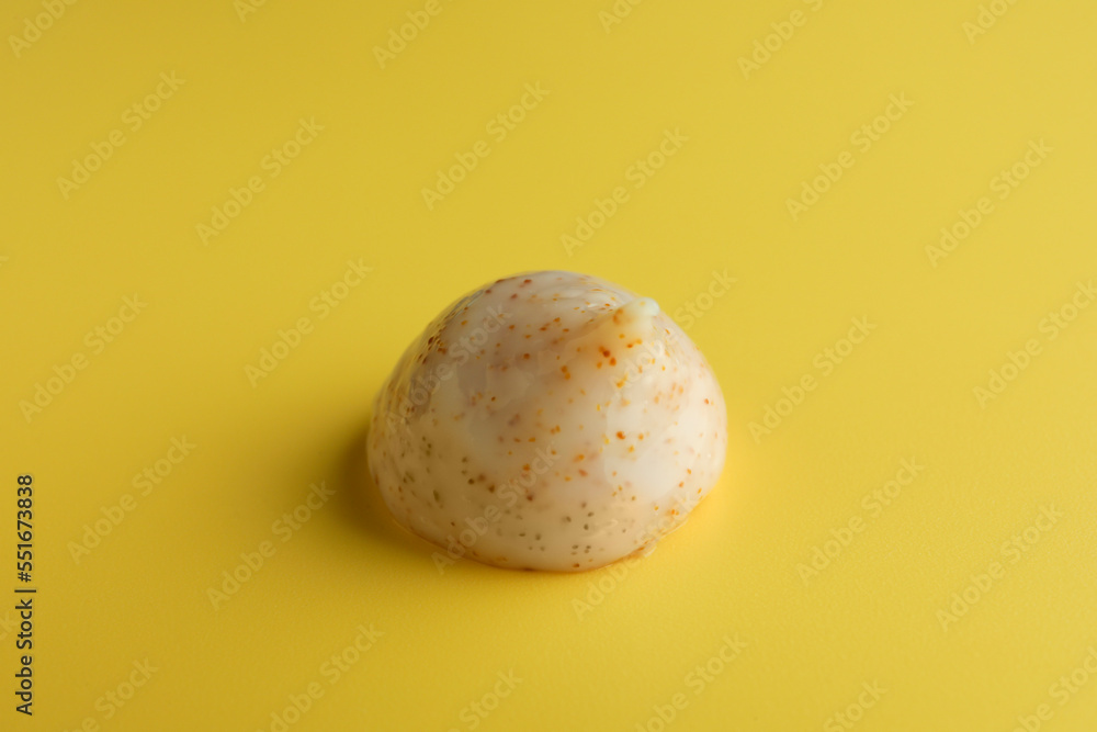 Sample of face scrub on yellow background Sample of face scrub on yellow background