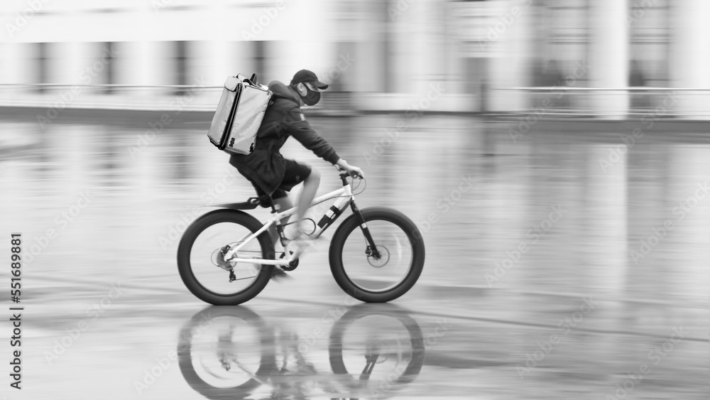 Obraz premium Blurred silhouette of a cyclist on a city street
