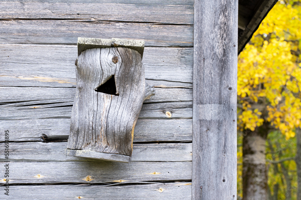 Wooden nest box on a wall in a farmstead in Finland, Northern Europe Wooden nest box on a wall in a farmstead in Finland, Northern Europe