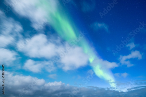Aurora Borealis. Northern Lights as a background. A winter night landscape with bright lights in the sky. Landscape in the north in winter time.