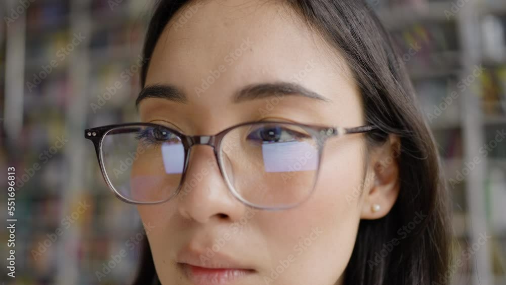 Concentrated Asian woman in glasses works on computer Concentrated Asian woman in glasses works on computer