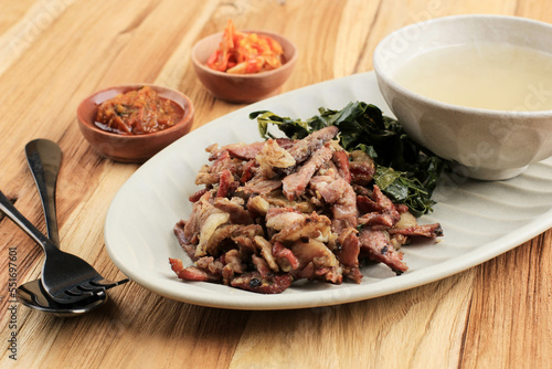Sei Sapi or Beef Sei is Indonesia Traditional Smoked Beef, Served with Boiled Cassava Leaves and Sambal Luat