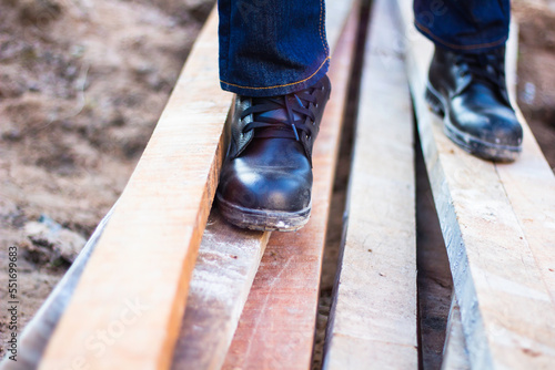 Wear safety shoes to ensure safety at work. construction workers wear safety shoes. concept construction workers work on the stairs