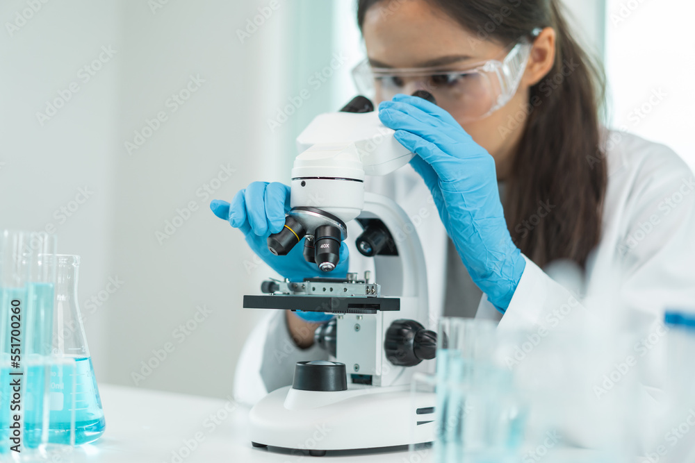 researcher using microscope analyse cell in medical lab. researcher using microscope analyse cell in medical lab.