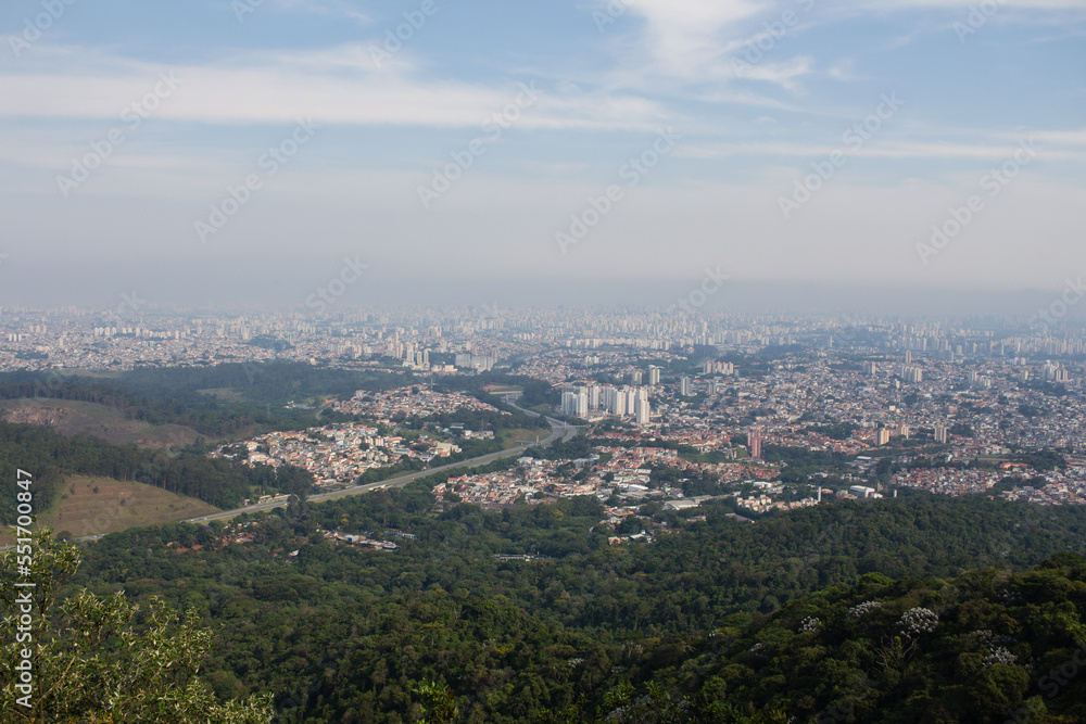 Vista Oeste do Parque Estadual do Jaraguá - SAO PAULO, SP, BRAZIL - NOVEMBER 13, 2022: View of the west side of the city from the peak of Jaragua, with the Bandeirantes highway in the center.