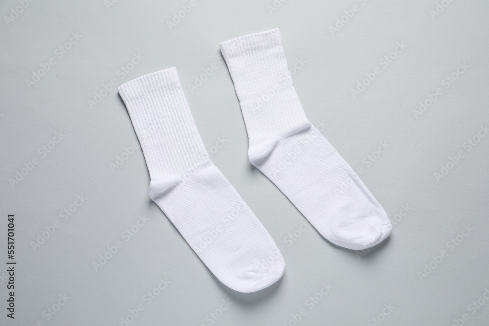 Pair of white socks on light grey background, flat lay Pair of white socks on light grey background, flat lay