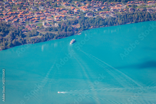 Aerial view of Swiss Alps and Lake Brienz with ferry boat at sunset  Interlaken