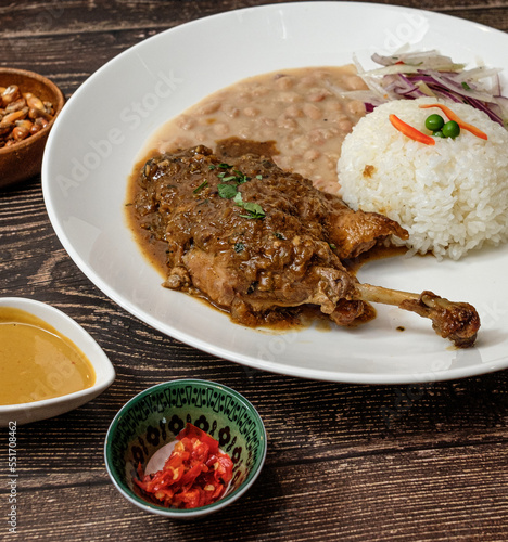 white beans with chicken and beef, served with rice and red onion seasoned photo