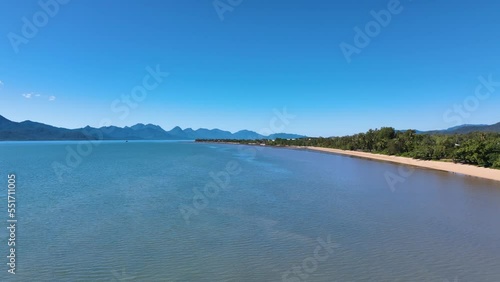 Aerial over a sun drenched tropical beach at Cardwell Queensland Australia photo