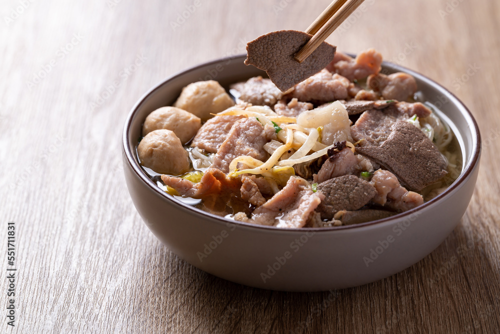 Rice noodles soup with pork eating by chopsticks, Asian food Rice noodles soup with pork eating by chopsticks, Asian food
